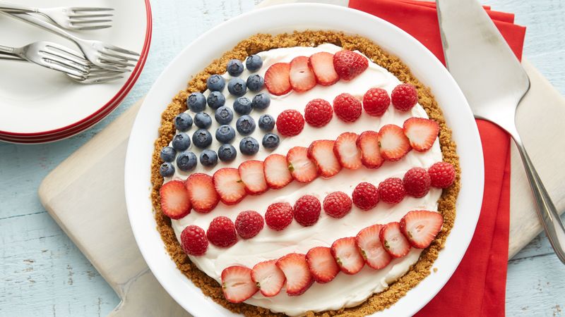 Fluffy Lemon Cheesecake Pie prepared recipe decorated with berries in U.S.A flag pattern