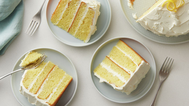 Slices of frosted Lemon Velvet Cream Cake prepared recipe on individual plates