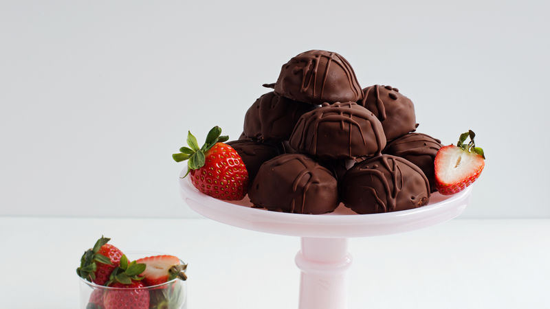Easy Chocolate Covered Frozen Yogurt Bonbons prepared recipe on a platter with strawberries