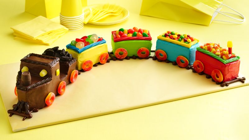 A cake structured and decorated like a train 